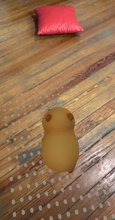 Capybara facing red pillow